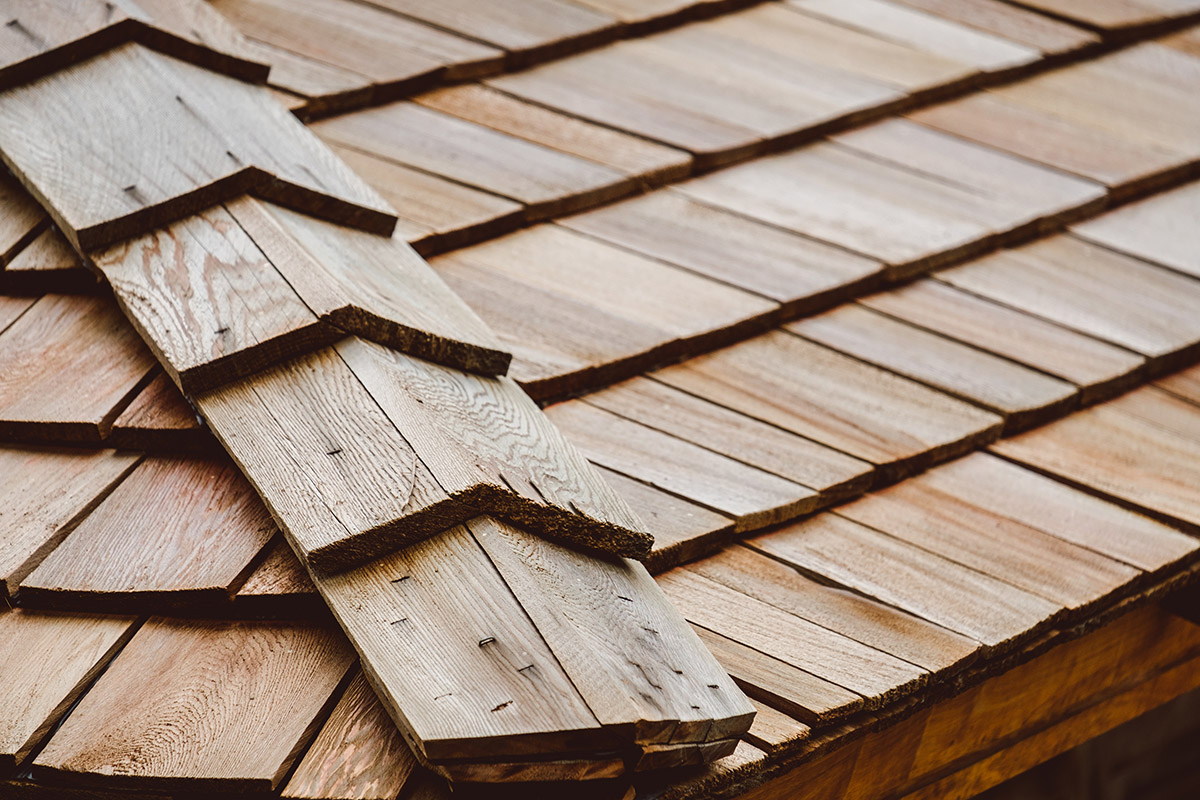 Close view of overlapping cedar shakes with visible grain along a roof edge